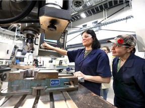 CNC Industrial Mechanical Millwright students Christine Coral, left, Julie Hughes, right, Angelica Tejeda and Nunan Regina Nimene, both behind, work on a CNC mill during class at St. Clair College's Ford Centre for Excellence in Manufacturing November 6, 2018.  25 women are enrolled in the pre-apprenticeship CNC program.