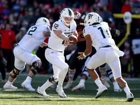 Rocky Lombardi of the Michigan State Spartans hands the ball off to Connor Heyward during the second half against the Maryland Terrapins at Capital One Field on November 3, 2018 in College Park, Maryland.