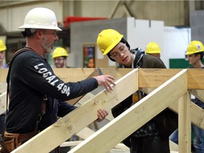 Kingsville District High School student Braedan DeSanti, right, is shown how it's done by carpenter Alex Paterson of Carpenters Local 494 during a workshop November 20, 2018.