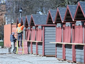 Structure builders Terry Powell, left, and Joel Folkeringa prepare vendor cabins at Jackson Park, all part of this year's Bright Lights Windsor on Nov. 21, 2018.  The vendor cabins measure 12-feet wide by 10-feet deep and are being constructed in the parking lot at Sunken Gardens.  Other workers including electricians are busy getting lights wired for another season of Bright Lights Windsor.