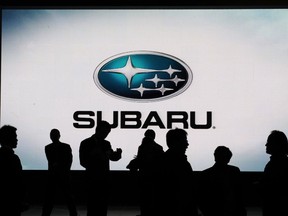 (FILES)Members of the media stand in front of the Subaru sign at the New York International Auto Show in this April 9, 2009 photo in New York.