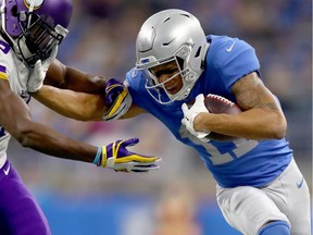 Marvin Jones of the Detroit Lions fights off defender Xavier Rhodes of the Minnesota Vikings after catching a pass during the first half at Ford Field on November 23, 2017 in Detroit, Michigan.