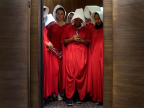 Women dressed as characters from the novel-turned-TV series "The Handmaid's Tale" stand in an elevator at the Hart Senate Office Building  as Supreme Court nominee Brett Kavanaugh starts the first day of his confirmation hearing in front of the US Senate on Capitol Hill in Washington DC, on September 4, 2018. - President Donald Trump's newest Supreme Court nominee Brett Kavanaugh is expected to face punishing questioning from Democrats this week over his endorsement of presidential immunity and his opposition to abortion. Some two dozen witnesses are lined up to argue for and against confirming Kavanaugh, who could swing the nine-member high court decidedly in conservatives' favor for years to come. Democrats have mobilized heavily to prevent his approval.