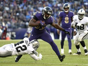 Baltimore Ravens running back Gus Edwards (35) rushes the ball against Oakland Raiders defensive back Karl Joseph in the second half of an NFL football game, Sunday, Nov. 25, 2018, in Baltimore.