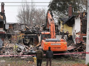 An excavator clears debris from the aftermath of the fire scene at 1258 to 1270 Argyle Road in Windsor on Nov. 12, 2018.