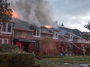 WIndsor firefighters direct water hoses at the flames that spread through 1258 to 1270 Argyle Rd. on the morning of Nov. 10, 2018.