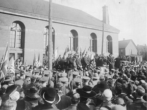 Military personal and civilians gather outside the Windsor Armouries on November 11, 1918 to mark the end of the First World War.