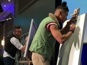 Artists Asaph Maurer, left, and Eugenio Mendoza perform during a live art battle at the fifth annual Artilicious to support the Kidney Foundation of Canada.