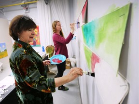 The Windsor Endowment for the Arts organization held its annual general meeting on Monday, November 12, 2018 at the SHO Studios in Walkerville. An open house was held prior to the meeting to showcase local artists. Lorraine Steele, left, and Tracey Green paint a background for an interactive art experiment during the event.
