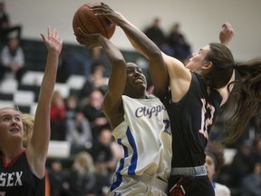 Kennedy's Alisha Murray is defended by Essex's Kim Orton on a drive to the basket in the WECSSAA senior girls' AA basketball final at the St. Clair College SportsPlex on Sunday.