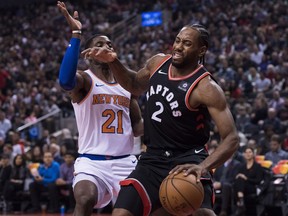 Toronto Raptors forward Kawhi Leonard (2) battles for the ball against New York Knicks guard Damyean Dotson (21) during first half NBA basketball action in Toronto on Nov. 10, 2018.