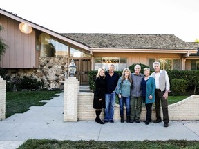 In this Thursday, Nov. 1 2018, photo provided by HGTV, members of the "The Brady Bunch" cast from left to right, Maureen McCormack, Christopher Knight, Susan Olsen, Mike Lookinland, Eve Plumb and Barry Williams pose in front of the original Brady home in the Studio City neighborhood in Los Angeles. The cast members gathered Thursday at the home that was featured in the opening and closing of the sitcom. HGTV purchased the home in the Studio City neighborhood in Los Angeles for its new series, "A Very Brady Renovation." HGTV plans to expand the home without compromising its street view and reimagine the show's interior design. The program is set to premiere in September 2019. (Courtesy of HGTV via AP)