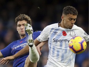 Chelsea's Marcos Alonso, left, duels for the ball with Everton's Dominic Calvert-Lewin during the English Premier League soccer match between Chelsea and Everton at Stamford Bridge stadium in London, Sunday, Nov. 11, 2018.