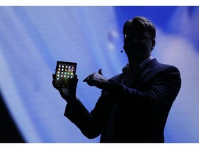 Justin Denison, SVP of Mobile Product Development, shows off the Infinity Flex Display of a folding smartphone during the keynote address of the Samsung Developer Conference Wednesday, Nov. 7, 2018, in San Francisco.