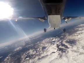 Scientists from NASA's Jet Propulsion Laboratory fly over the Tuolumne River Basin of California's Sierra Nevada mountain range in a de Havilland Twin Otter plane to measure the snowpack in 2014.