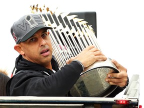 Boston Red Sox manager Alex Cora holds the World Series trophy during the 2018 World Series victory parade on October 31, 2018 in Boston. (Adam Glanzman/Getty Images)