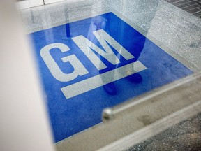 FILE - In this Jan. 10, 2013, file photo, the logo for General Motors decorates the entrance at the site of a GM information technology center in Roswell, Ga.