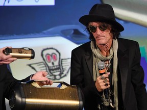 Aerosmith guitarist Joe Perry looks at some speakers in his Monster collection during a Monster Inc. press event for CES 2018 at the Mandalay Bay Convention Center on Jan. 8, 2018 in Las Vegas, Nevada. (Ethan Miller/Getty Images)