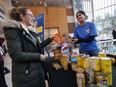 More than six million people and 6,000 charities and businesses across the country united for Canada's sixth-annual GivingTuesday on November 27, 2018. At the University of Windsor a group of students were doing their part to pitch in. Cori Dufresne, left, makes a food donation at a station manned by fellow student Himaja Yedidi.