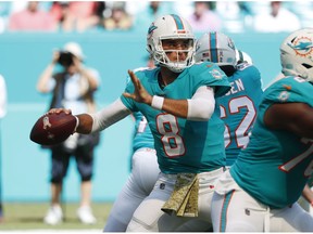 Miami Dolphins quarterback Brock Osweiler (8) looks to pass, during the first half of an NFL football game against the New York Jets, Sunday, Nov. 4, 2018, in Miami Gardens, Fla.