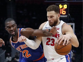 New York Knicks forward Noah Vonleh (32) reaches for the ball against Detroit Pistons forward Blake Griffin (23) during the second half of an NBA basketball game Tuesday, Nov. 27, 2018, in Detroit.