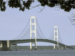 This 2002 file photo shows the Mackinac Bridge that spans the Straits of Mackinac from Mackinaw City, Mich. Michigan Gov. Rick Snyder hopes to use the final weeks of his tenure to lock in a deal allowing construction of a hotly debated oil pipeline tunnel beneath a channel linking two of the Great Lakes — a plan his successor opposes but may be powerless to stop. The Republican and his team are working on several fronts to seal an agreement with Canadian oil transport giant Enbridge for replacing the underwater segment of its Line 5, which carries oil and natural gas liquids between Wisconsin and Ontario and traverses northern Michigan.
