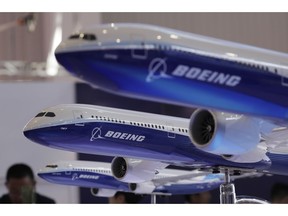 FILE- In this Nov. 6, 2018, file photo models of a Boeing passenger airliner are displayed during the 12th China International Aviation and Aerospace Exhibition, also known as Airshow China 2018, in Zhuhai city, south China's Guangdong province. Boeing Co. canceled a conference call that it scheduled for Tuesday, Nov. 20, with airlines to discuss issues swirling around its newest plane, which has come under close scrutiny after a deadly crash in Indonesia.