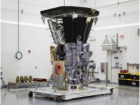FILE - In this July 6, 2018 file photo, NASA's Parker Solar Probe sits in a clean room at Astrotech Space Operations in Titusville, Fla., after the installation of its heat shield. Parker has made its first close approach to the sun, just 2 1/2 months after liftoff. The spacecraft flew within 15 million miles (24 million kilometers) of the sun's surface Monday night, Nov. 5. Its speed topped 213,000 miles (342,000 kilometers) an hour relative to the sun, as it penetrated the outer solar atmosphere, or corona. No spacecraft has ever gotten so close to our star.