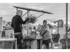 This image released by Netflix shows filmmaker Alfonso Cuaron, left, and actress Yalitza Aparicio on the set of "Roma." Cuaron's "Roma" has dominated the New York Film Critics Circle Awards, winning best film, best director and best cinematography. The film is Netflix's most acclaimed release yet, and it's widely expected to contend for best picture at the Academy Awards.