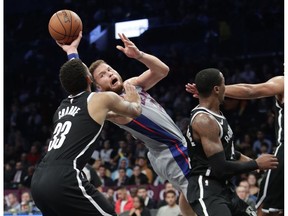 Detroit Pistons' Blake Griffin passes the ball away from Brooklyn Nets' Allen Crabbe (33) during the first half of an NBA basketball game Wednesday, Oct. 31, 2018, in New York.