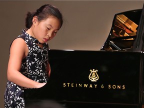 A handful of aspiring local pianists had a once-in-a-lifetime opportunity on Tuesday, November 13, 2018, to perform on a Steinway Spirio. The instrument is considered one of the finest pianos produced by the preeminent piano makers. Emily Yang performs a piece on the piano during the event held at the Capitol Theatre.