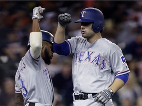 Pete Kozma, seen here at right with the Texas Rangers, signed a minor-league deal with the Detroit Tigers on Friday.