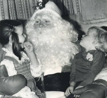 Following the parade in 1979, Chrissy Foley (left) and Heather Cowell give their lists to Santa Claus.