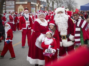The 'real' Santa Claus and Mrs. Claus pose for a photo before the start of the 10th annual Super Santa Run in Amherstburg on Nov. 17, 2018. The event was presented by the Essex Regional Conservation Foundation in partnership with Amherstburg's River Lights Winter Festival.