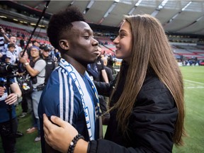 Vancouver Whitecaps midfielder Alphonso Davies, left, receives a hug from Canadian women's national soccer team forward Jordyn Huitema after playing his final match as a member of the MLS soccer team, in Vancouver, on October 28, 2018. Teenage stars Alphonso Davies and Jordyn Huitema have already made their soccer mark for Canada. Now it seems they are making news off the pitch. Social media postings by the 18-year-old Davies and 17-year-old Huitema show them arm-in-arm -- complete with rose emoji -- and also in costume for Halloween with Huitema dressed like a member of the "Orange is the New Black" cast.