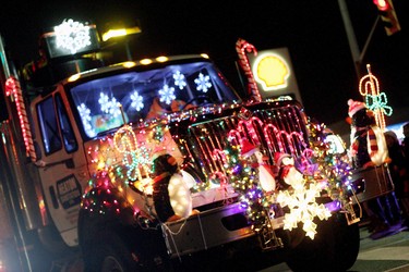 A Heaton Sanitation truck driver and his holiday-trimmed rig roll down Sandwich Street in Amherstburg as part of the Santa Claus parade in 2014.