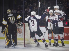 Windsor' Spitfires defenceman Grayson Ladd, left, joins Luke Kutkevicius, Cody Morgan, and Curtis Douglas after a first-period goal in Saturday's 5-2 win over the Sarnia Sting at the WFCU Centre.