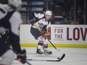 WINDSOR, ONT:. NOVEMBER 25, 2018 -- Windsor's Cody Morgan passes the puck out in front of the London net in OHL action between the Windsor Spitfires and the London Knights at the WFCU Centre, Sunday, November 25, 2018.