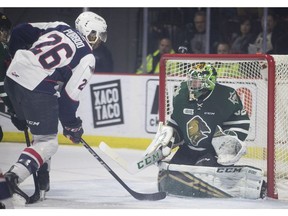 WINDSOR, ONT:. NOVEMBER 25, 2018 -- Windsor's Cole Purboo misses on a scoring opportunity against London's Joseph Raaymakers as the puck nearly misses the net in OHL action between the Windsor Spitfires and the London Knights at the WFCU Centre, Sunday, November 25, 2018.