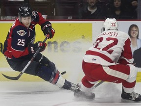 WINDSOR, ON. NOVEMBER 29, 2018. --  Kyle McDonald, left, of the Windsor Spitfires and Robert Calisti of the Sault Greyhounds battle for the puck during a game on Thursday, November 29, 2018, at the WFCU Centre in Windsor, ON. against the Sault Greyhounds.