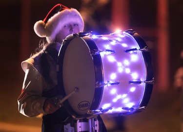 A lit up drummer marches during the Tecumseh Santa Claus Parade in 2012.