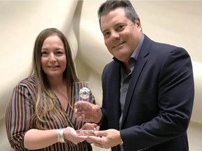 Tina Carlini, general manager of Thompson Emergency Freight and  Mark Bortolotti, marketing director, hold Thompson's SmartWay Excellence Award.