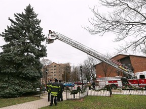 Students from General Brock Public School received some help from Windsor firefighters on Tuesday, November 27, 2018, as they decorated the official Sandwich Towne Tree in Mackenzie Hall Park. The students crafted ornaments for the tree and got a lift from firefighters on the ground and help from the aerial ladder truck to reach high into the tree.