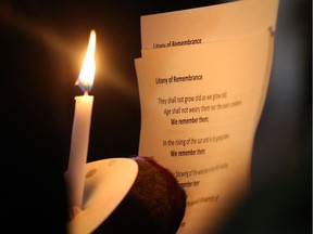 A candle lights up the Litany of Remembrance, part of a silent vigil held the night of Nov. 16, 2018, in downtown Windsor to highlight the opioid crisis.