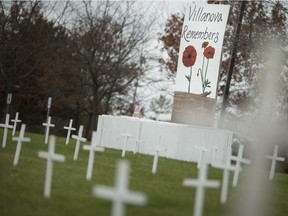 Three hundred crosses are displayed on the front lawn of St. Thomas of Villanova Catholic High School on Thursday, Nov. 8, 2018.