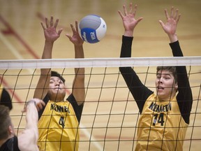 The Kennedy Clippers' Mu Htoo Eh, left, and Matthew Thompson, defend against a spike from York Mills on Friday at the OFSAA boys' AAA volleyball championship at the St. Clair College SportsPlex.