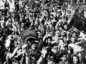 Crowds celebrate in a Windsor railway yard at the end of the Second World War.