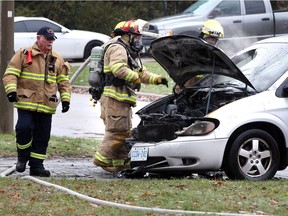 LaSalle firefighters, including Chief Dave Sutton, left, on the scene of a vehicle fire in the 1500 block of Minto Avenue in LaSalle on Dec. 1, 2018. The front end of a minivan was heavily damaged.