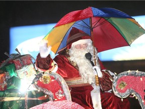 Santa waves to the sidelines at the start of the 2018 Santa Claus Parade on Ouellette Avenue.  Santa and his elves, and parade participants, kept their holiday spirits high during a persistent rain shower Saturday night.