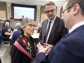 Environmental Commissioner of Ontairo Dr. Dianne Saxe, left,  ERCA general manager Richard Wyma speak with City of Windsor councillor Irek Kusmierczyk, right, during a break a multi-stakeholder workshop on climate change issues and challenges held at Great Lakes Institute for Environmental Research Wednesday.